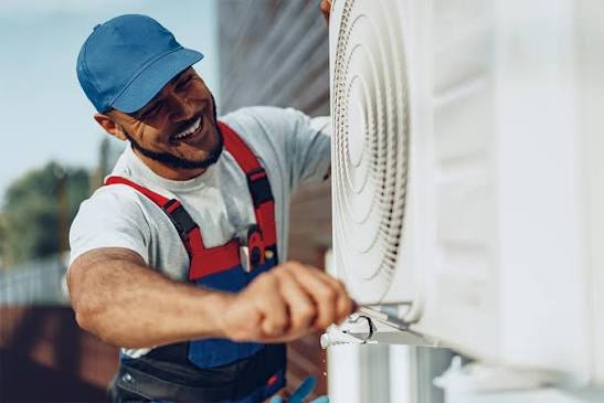 HVAC technician servicing an outdoor residential air conditioning unit
